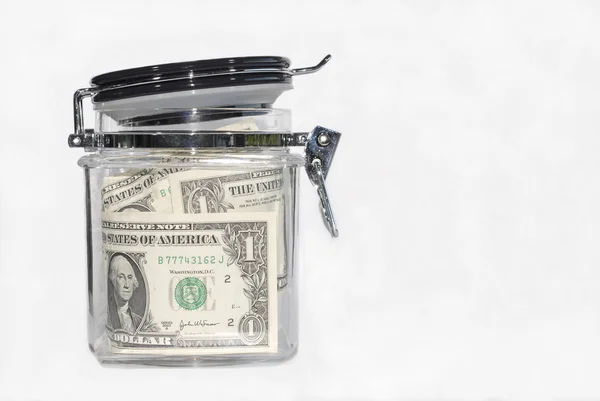 Dollar bills in a kitchen storage jar — Stock Photo, Image