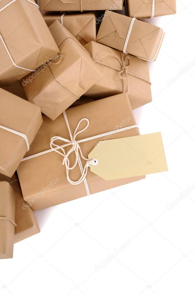 Untidy pile of brown parcels with label