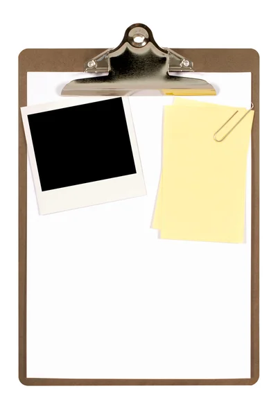 Clipboard with blank instant print picture and untidy note paper — Stock Photo, Image
