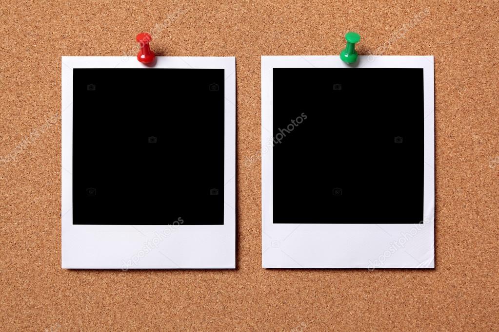 Two blank photos pinned to a cork board