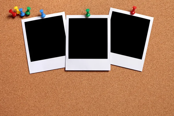 Three blank photos pinned to a cork board — Stock Photo, Image