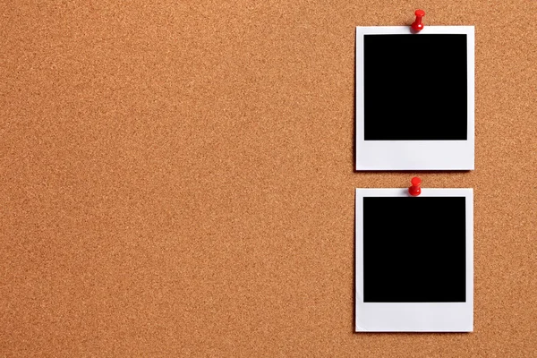 Two blank photos pinned to a cork board — Stock Photo, Image