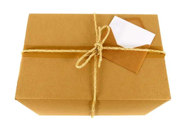 Cardboard box with blank message card — Stock Photo, Image