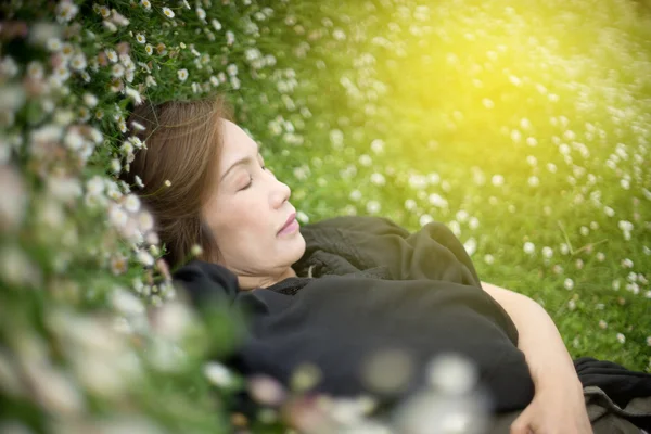 woman lay down flower garden