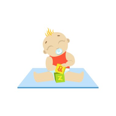 Küpleri ile oynayan kırmızı bebek