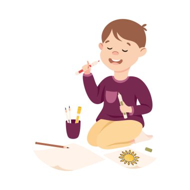 Yerlerde oturan sevimli çocuk keçeli kalemlerle resim çiziyor, şirin çocuk yaratıcı çizgi film temsilciliği yapıyor.