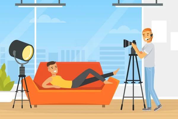 ( 영어 ) Young Man on Sofa posing in front of Photographer with Professional Camera Vector Illustration — 스톡 벡터