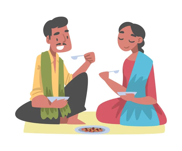 Hombre indio y personaje de mujer sentados en el suelo con el tazón teniendo comida Vector ilustración — Vector de stock