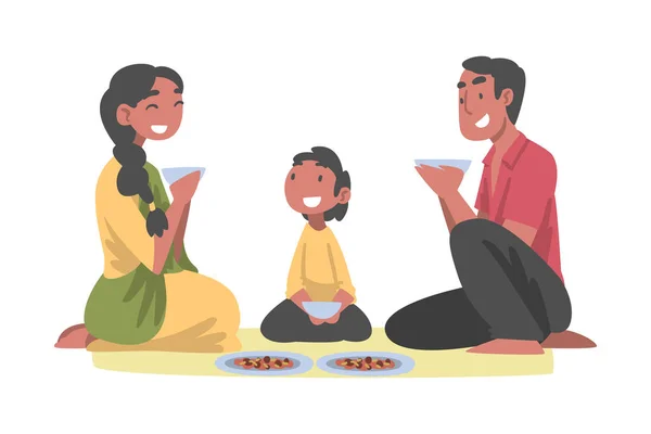 Indiaas gezin met kleine zoon zit op de vloer samen eten Vector Illustratie — Stockvector