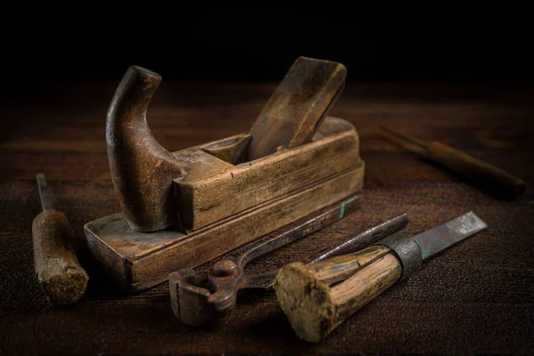 Old carpentry tools on a wooden background