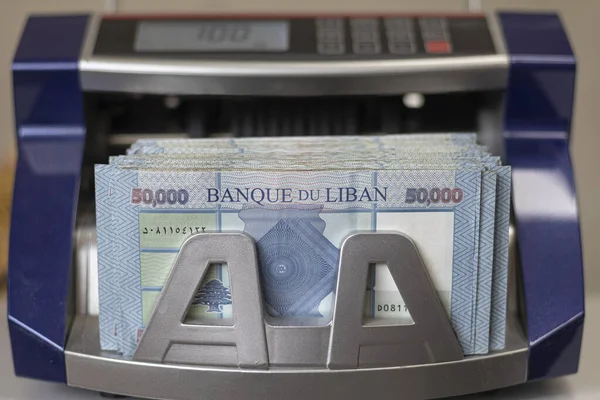 Lebanese Lira (Pound) Currency in a money counting machine.