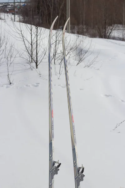 A pair of skis stick out in the snow. Ski vacation.