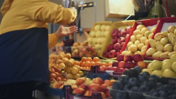 Achteraanzicht van de mens neemt een papieren zak van verkoper in de markt — Stockvideo