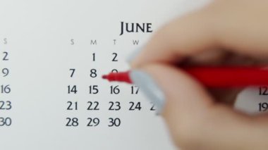 Takvimde kırmızı kalemli bir kadın el çemberi günü. İş Temel Duvar Takvimi Planlayıcı ve Düzenleyici. 8 Haziran