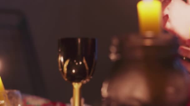 Side view of male fortune teller moving hands above the magic candle — Stock Video