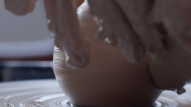 Potter çömlekçide çömlek modelleme araçlarıyla kil ürünü yapıyor.