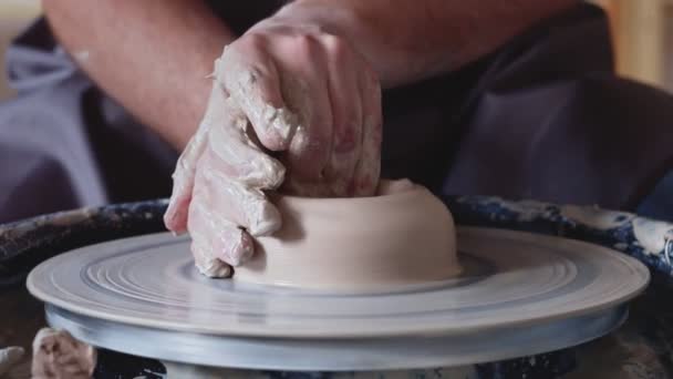 Hand work on pottery wheel, shaping a clay pot, student make of clay pot at studio — Stock Video