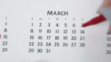 Takvimde kırmızı kalemli bir kadın el çemberi günü. İş Temel Duvar Takvimi Planlayıcı ve Düzenleyici. 14 Mart