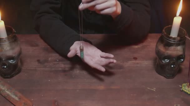 Nahaufnahme der jungen Hexe Wahrsagerin verwendet einen blauen magischen Kristall und ihre Hand in einem mystischen Ritual — Stockvideo