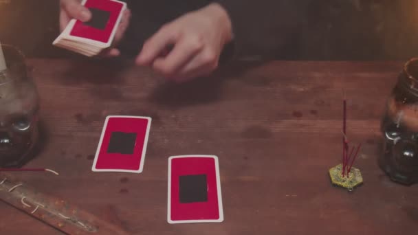 Κοντινό πλάνο του μυστηριώδους μάγου αρσενικό μάντισσα χρησιμοποιεί tarot κάρτα και τηλέφωνο για να διαβάσει το μέλλον — Αρχείο Βίντεο