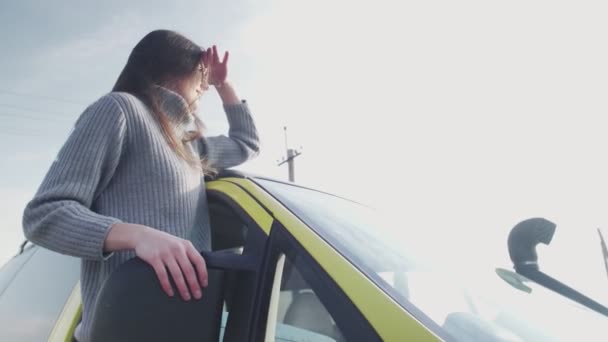 Young woman with sunglasses leaned out of the car window — Stock Video