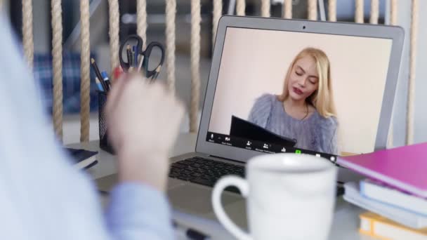 Close up of two young stundents talking in video chat and doing homework — Stock video