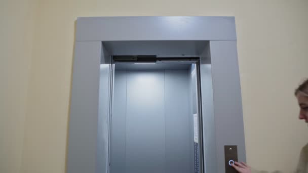 Νεαρό ευτυχισμένο ζευγάρι εισέρχεται στο ασανσέρ με κουτιά από χαρτόνι και πτυσσόμενη καρέκλα κινείται σε νέο διαμέρισμα — Αρχείο Βίντεο