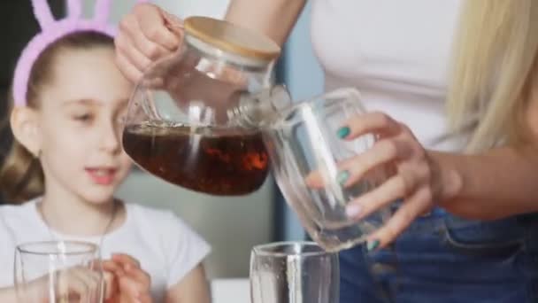 Happy Easter. Preparing the family for Easter. Close up of woman pours tea into cups — Stock Video