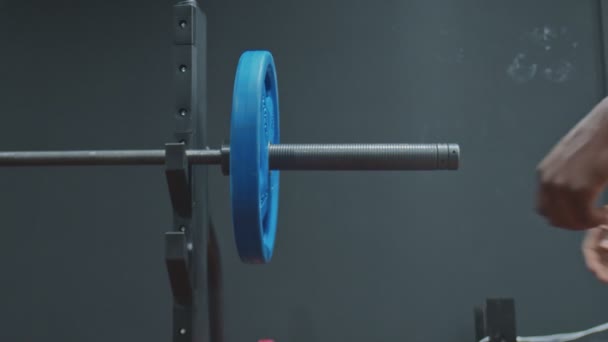 Gros plan de musclé afro homme met hors plaque de poids sur poignée d'haltère olympique — Video