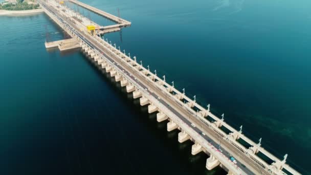 Dam with roads with cars on river, aerial view. Hydroelectric power station, hydro energy — Stock Video