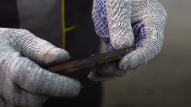 Auto mechanic working on car engine in mechanics garage. He holds brake pad in hands — Stock Video