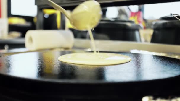 Zijaanzicht van het maken van Russische pannenkoek op professionele pan. Chef giet deeg op pan — Stockvideo