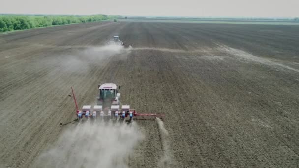 Farmers In Tractors Sow Seeds In Soil Of Agricultural Field On Spring Day Aerial — Stock Video