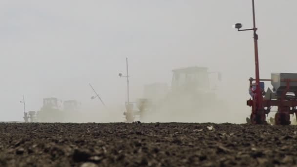 Farmers In Tractors Sow Seeds In Soil Of Agricultural Field On Spring Day — Stock Video