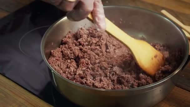 Chef frys chopped meat in a frying pan — Stock Video