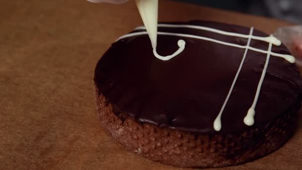 Chef decorar la parte superior de la pequeña tarta con una crema blanca — Vídeo de stock