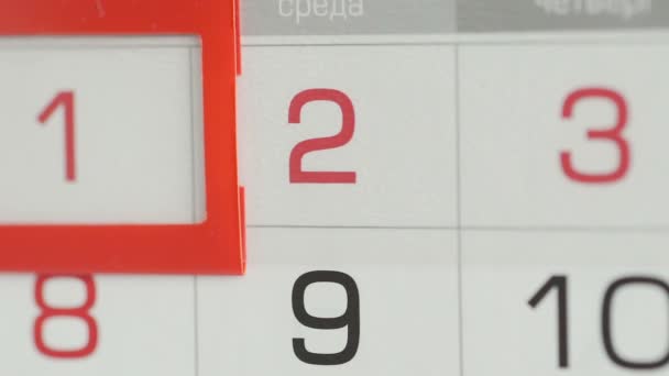 Close-up of a womans finger moves the date pointer on the calendar — Stock Video