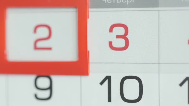 Close-up of a womans finger moves the date pointer on the calendar — Stock Video