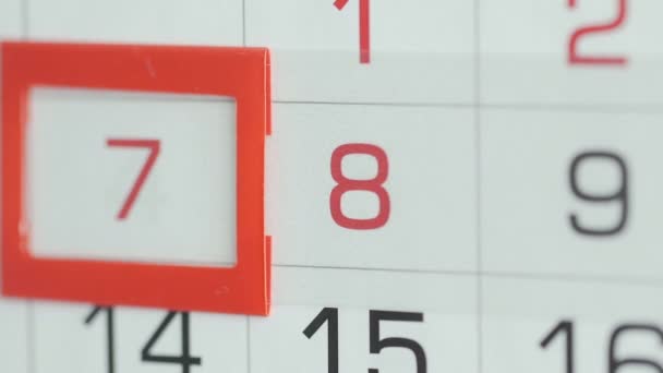 Close-up of a womans finger moves the date pointer on the calendar — Stock Video