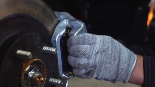 The car mechanic unscrews the brake pads. Close-up — Stock Video