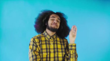 Blah, Blah, Blah. Sıkılmış bir Afro-Amerikalı, bir Blah-Blah jesti, konuşmalardan ve ilginç olmayan bilgilerden sıkılmış, mavi bir arka planda poz veriyor.