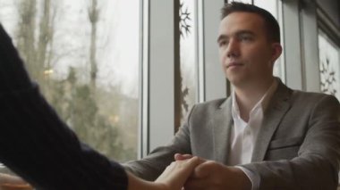 Kız elini erkek arkadaşlarının avucunun içine koyuyor. Yakın çekim.