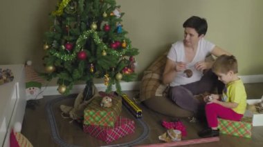 Anne ve çocuk Noel ağacını süslüyor. Noel zamanı. Şenlik havası.