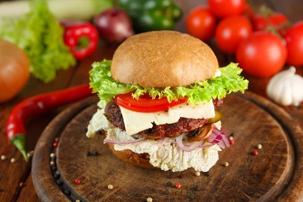 Meet and cheese burger at wooden desk — Stock Photo, Image