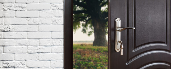 Entrance door half opened to the nature background