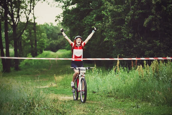 Jeune femme gagne la ligne d'arrivée de la course — Photo