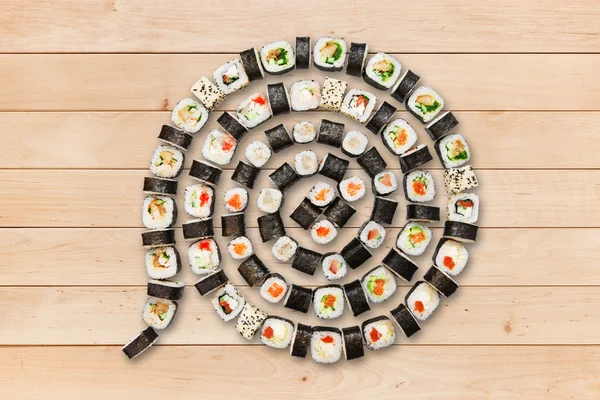 Set of maki sushi and rolls at wood. — Stockfoto