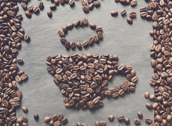 Cup from coffee beans at stone background — Stock Photo, Image