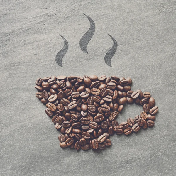 Cup from coffee beans at stone background — Stock Photo, Image