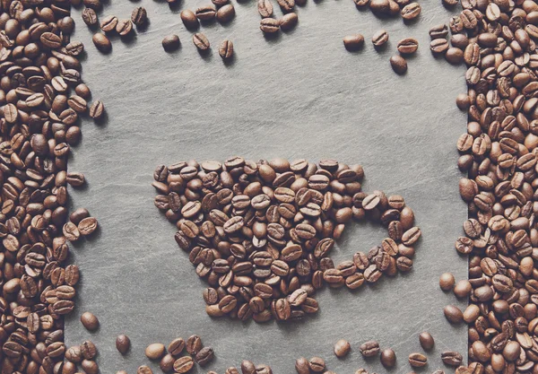 Cup from coffee beans at stone background — Stock Photo, Image